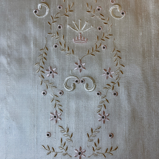  heirloom embroidery on cream silk with delicate eyelets, floral motifs, and fine satin stitches.
