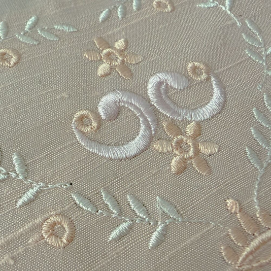  heirloom embroidery on cream silk with delicate eyelets, floral motifs, and fine satin stitches.
