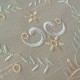  heirloom embroidery on cream silk with delicate eyelets, floral motifs, and fine satin stitches.
